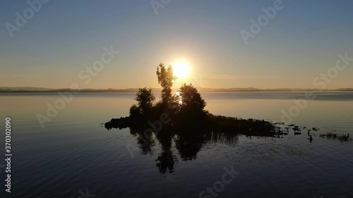 sunset on a mountain lake of the southern Urals Uvildy. reflection in the water. island in the middle of the lake.  photo