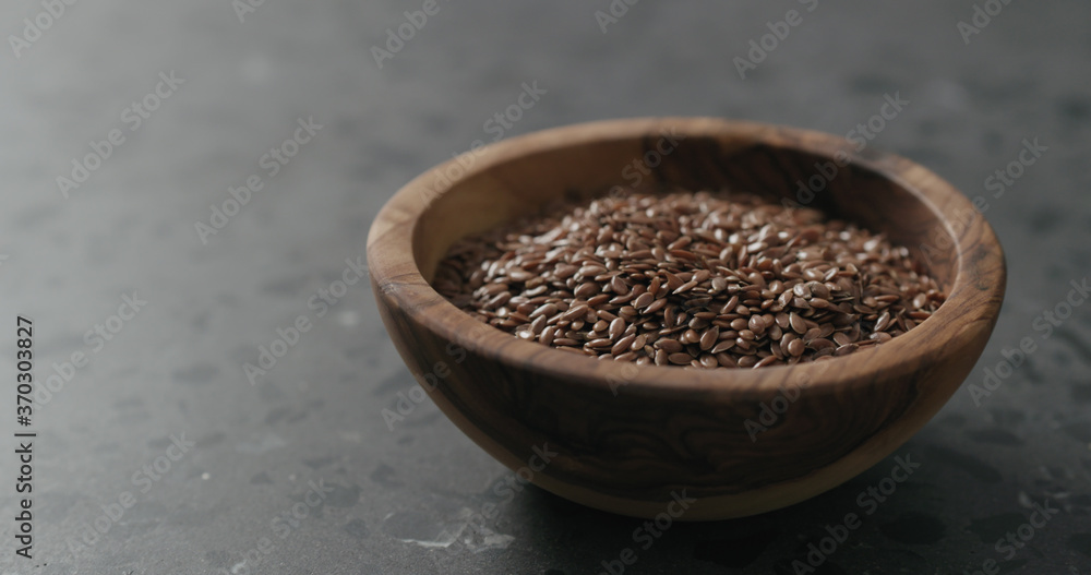 flaxseed in olive bowl on terrazzo countertop with copy space flaxseed in olive bowl on terrazzo countertop with copy space