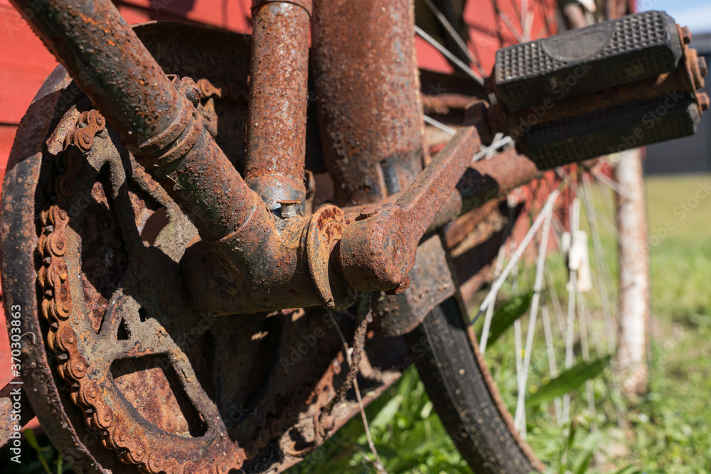 Details on an old rusty bicycle with pedal arm and chain Details on an old rusty bicycle with pedal arm and chain