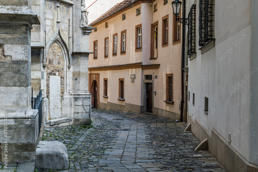 tight picturesque street in Prague with old ancient buildings