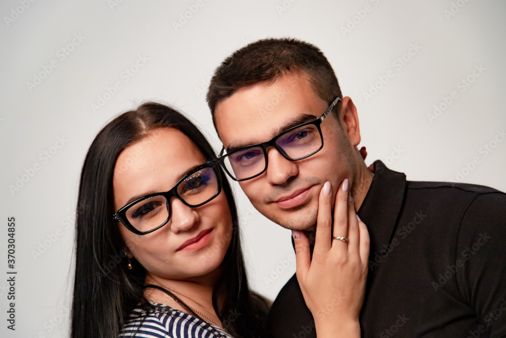 Portrait of stylish young couple. Macho man and woman both wearing glasses. Portrait of stylish young couple. Macho man and woman both wearing glasses.