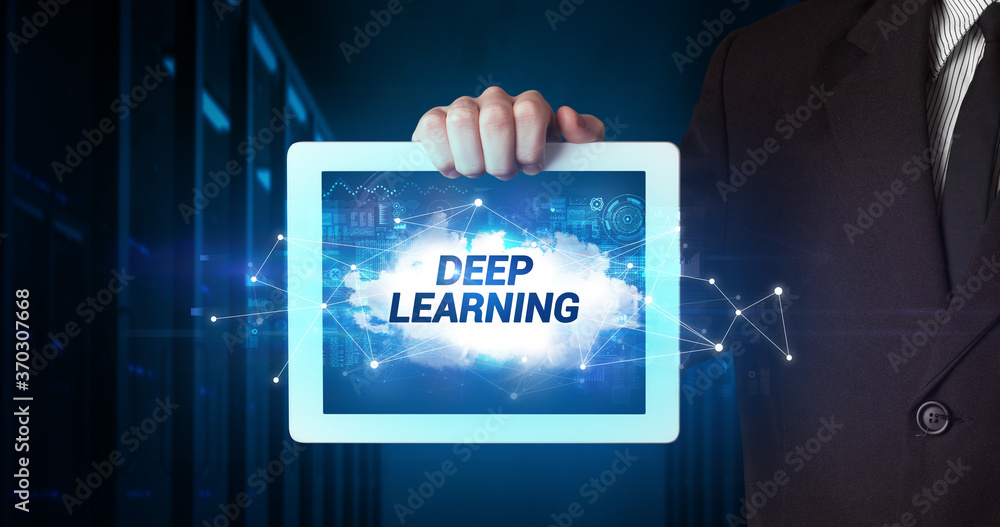 Young business person working on tablet and shows the inscription: DEEP LEARNING Young business person working on tablet and shows the inscription: DEEP LEARNING