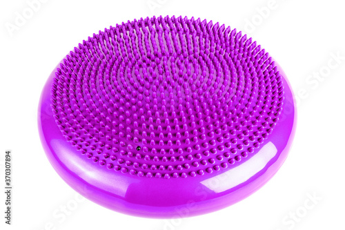 Purple inflatable balance disk isoleated on white background, It is also known as a stability disc, wobble disc, and balance cushion.