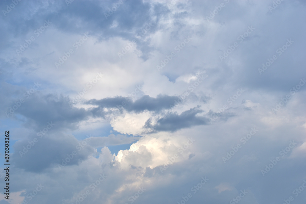 Evening sky with Cumulus clouds and sunset sun Evening sky with Cumulus clouds and sunset sun