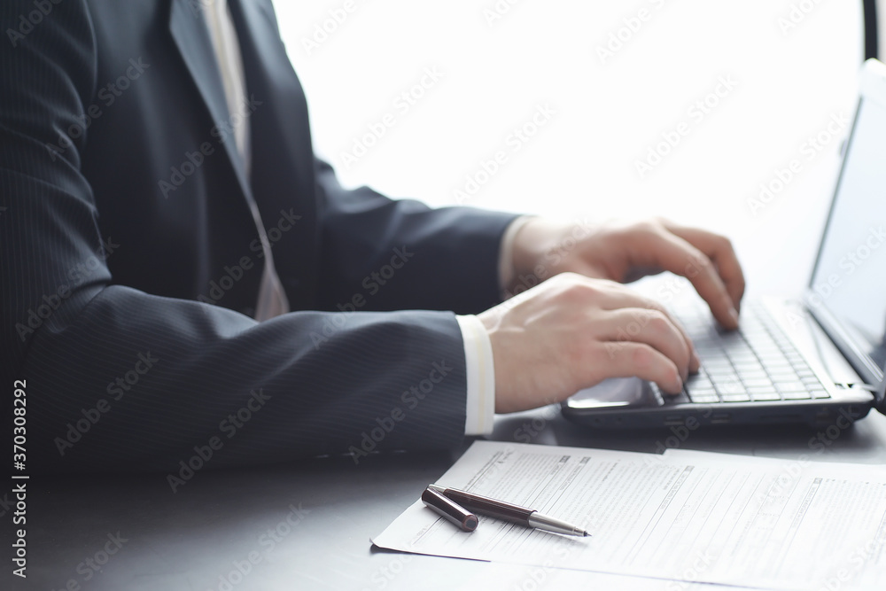 Manager works at a laptop in the office. Businessman makes an online transaction. Trading on the exchange via the Internet. Manager works at a laptop in the office. Businessman makes an online transaction. Trading on the exchange via the Internet.