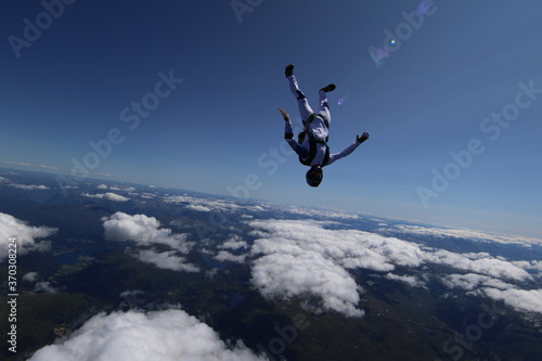 Skydivers over snowy mountains in Norway