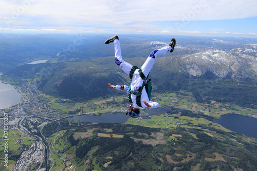Skydivers over snowy mountains in Norway