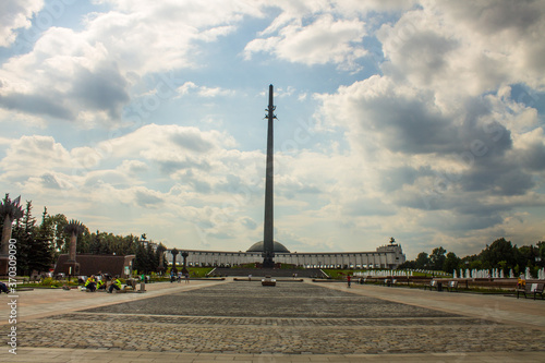 high spire-Victory Monument on Poklonnaya hill on a cloudy summer day and space for copying in Moscow Russia