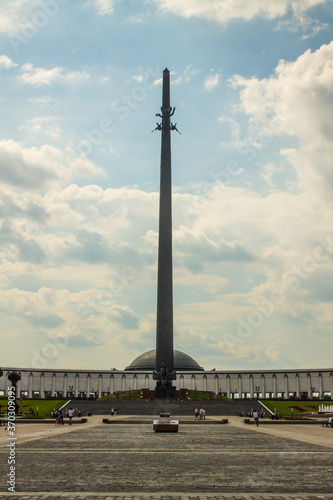 high spire-Victory Monument on Poklonnaya hill on a cloudy summer day and space for copying in Moscow Russia