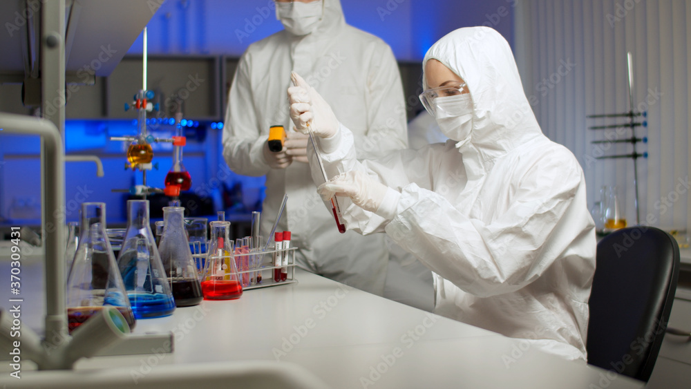 Biologist examining a virus sample in laboratory Biologist examining a virus sample in laboratory