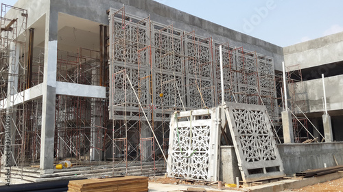 KUALA LUMPUR, MALAYSIA -AUGUST 16, 2018: GRC (Glass Fibre Reinforce Concrete) with Islamic geometry pattern installation work at the construction site by the construction workers. 
