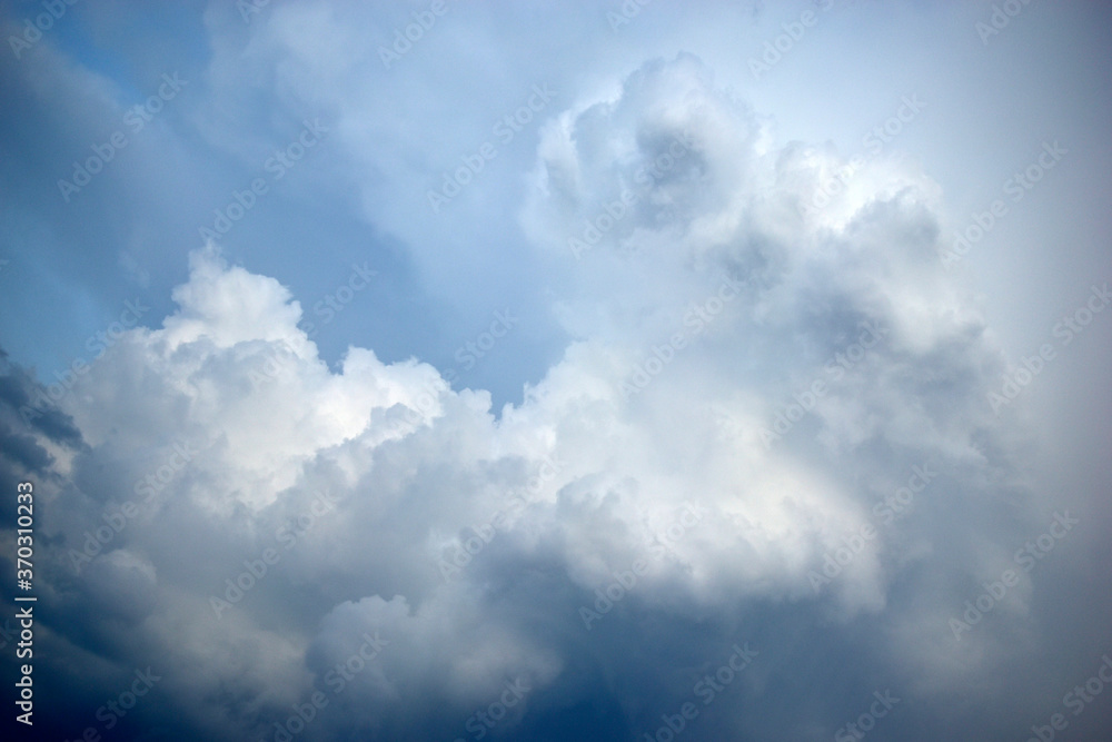 Pre-storm Cumulus blue clouds in the evening sky