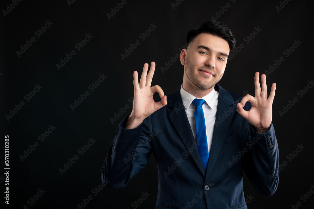 Portrait of business man wearing blue business suit and tie showing double ok gesture Portrait of business man wearing blue business suit and tie showing double ok gesture