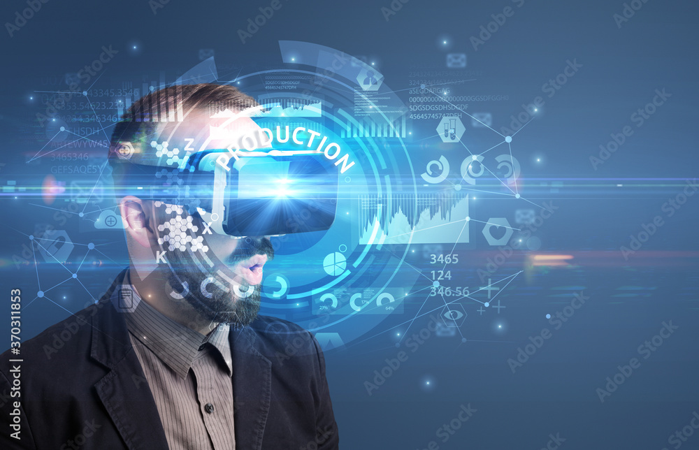 Businessman looking through Virtual Reality glasses with PRODUCTION inscription, innovative technology concept Businessman looking through Virtual Reality glasses with PRODUCTION inscription, innovative technology concept