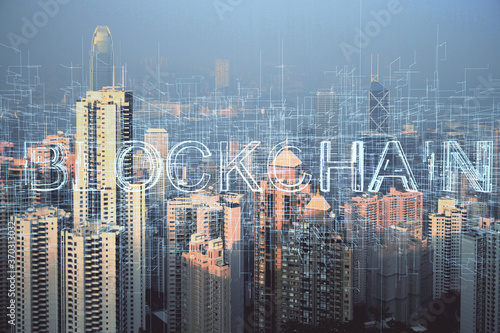 Double exposure of crypto currency theme hologram drawing and city veiw background. Concept of blockchain and bitcoin.