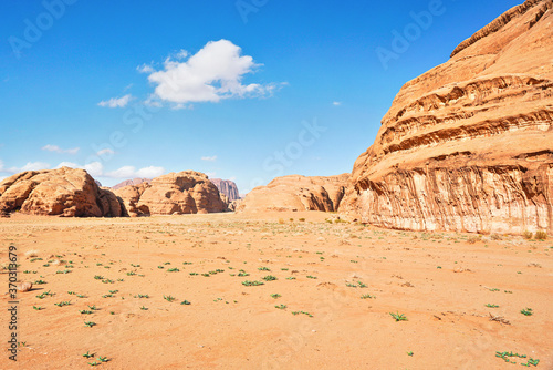 Rocky massifs on red sand desert, bright blue sky in background - typical scenery in Wadi Rum, Jordan © Lubo Ivanko