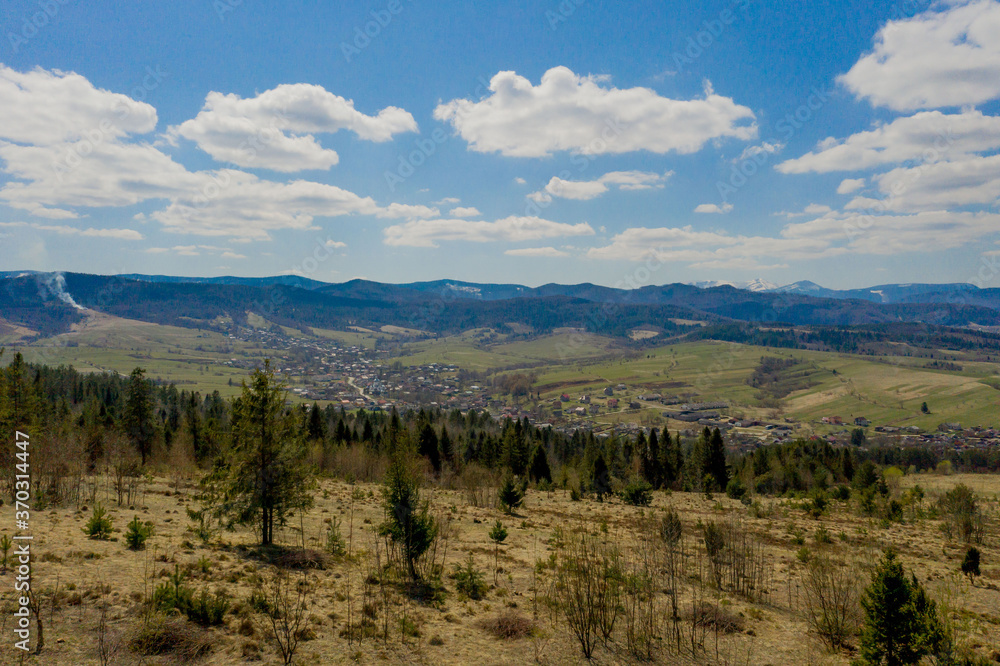 View of the Carpathian Mountains landscape in cloudy summer day. Mountain peaks, forests, fields and meadows, beautiful natural landscape View of the Carpathian Mountains landscape in cloudy summer day. Mountain peaks, forests, fields and meadows, beautiful natural landscape