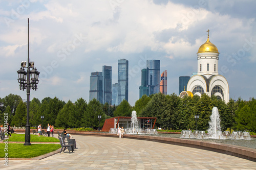 the Church of St. George on Poklonnaya hill in Victory Park and a view of the modern buildings of Moscow city Russia