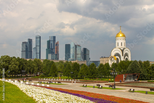 the Church of St. George on Poklonnaya hill in Victory Park and a view of the modern buildings of Moscow city Russia