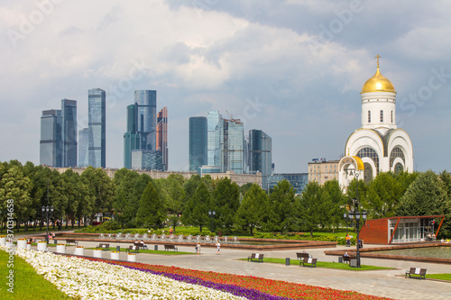 the Church of St. George on Poklonnaya hill in Victory Park and a view of the modern buildings of Moscow city Russia