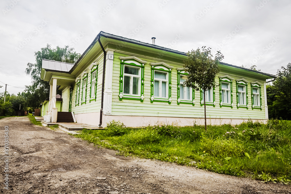 Traditional Russian wooden house in green colour. Green wooden vintage Museum lounge in Dmitrov, Moscow Region, Russia. Popular touristic landmark