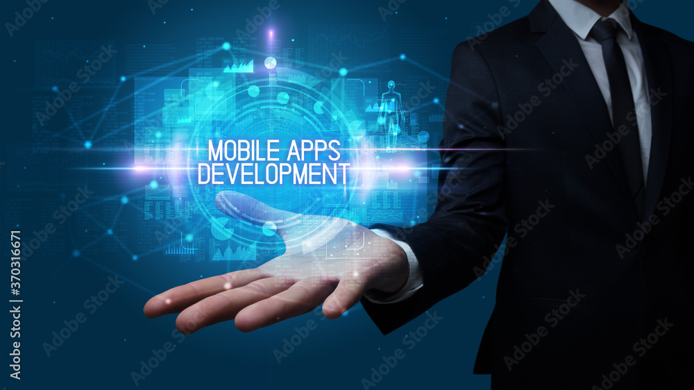 Man hand holding MOBILE APPS DEVELOPMENT inscription, technology concept Man hand holding MOBILE APPS DEVELOPMENT inscription, technology concept