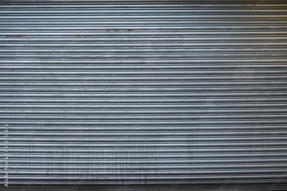 UK, London, Detail of a grey metal doorway garage door, close up, texture. UK, London, Detail of a grey metal doorway garage door, close up, texture.
