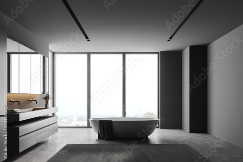 Grey bathroom with tub and sink  side view