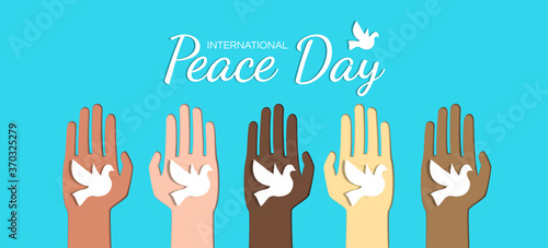 international peace day multiracial hands holding dove  banner design with  paper cut vector illustration