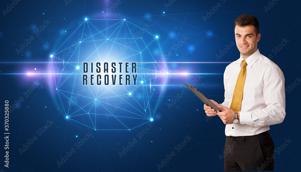 Businessman thinking about security solutions with DISASTER RECOVERY inscription Businessman thinking about security solutions with DISASTER RECOVERY inscription