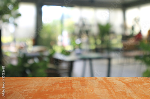 Wooden board empty table in coffee shop for background.