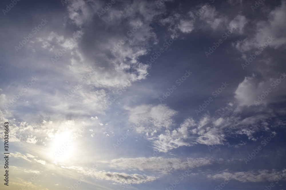 Obraz premium Panorama of the cloudy sky, including the solar disk and light cirrostratus clouds, resembling an open cloud ring in shape. A fine spring day in the Western Urals.