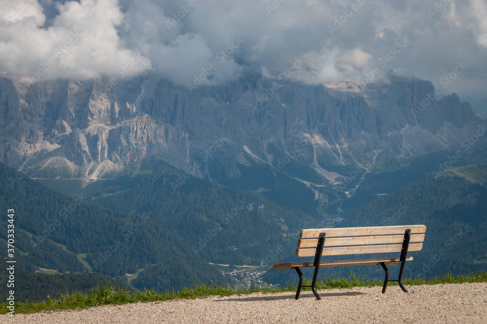Empty bench in front of Sella mountain group.