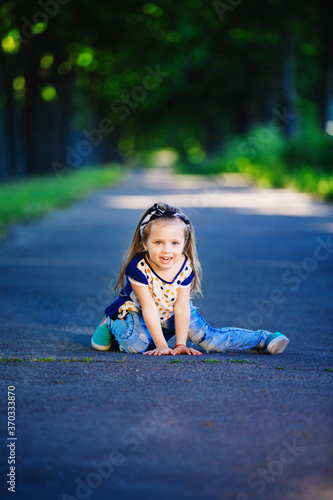 Cute little girl is having fun, jumping and laughing outdoors. happy childhood