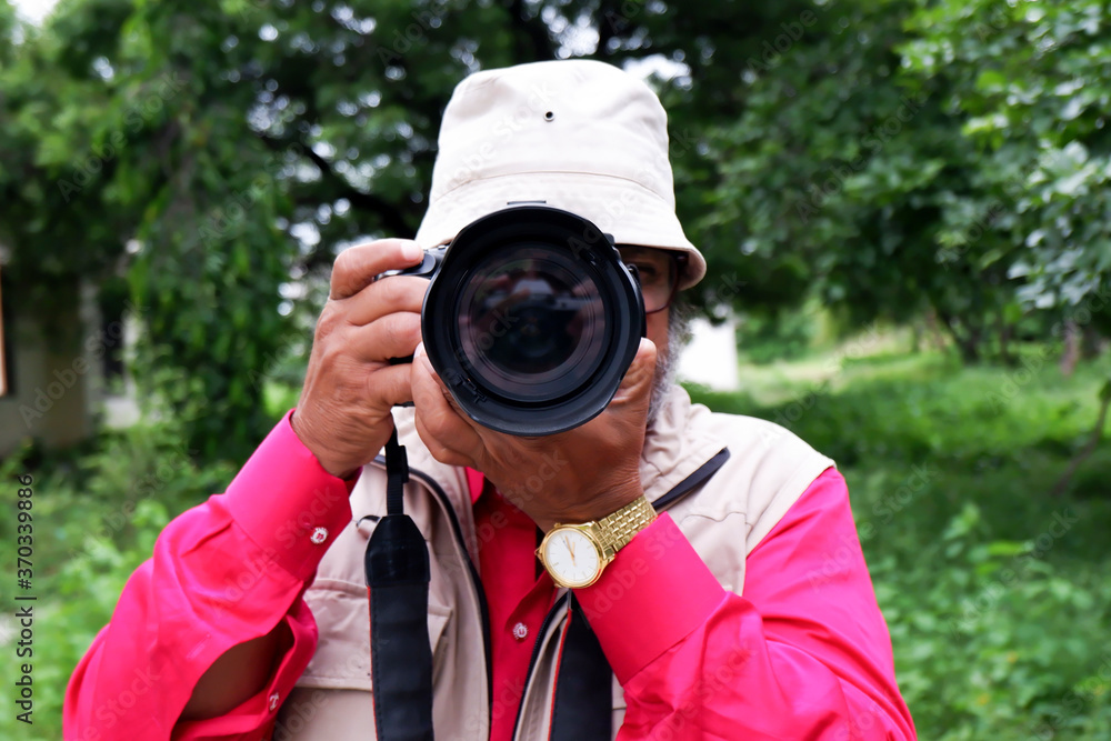handsome young professional photographer clicking photos handsome young professional photographer clicking photos