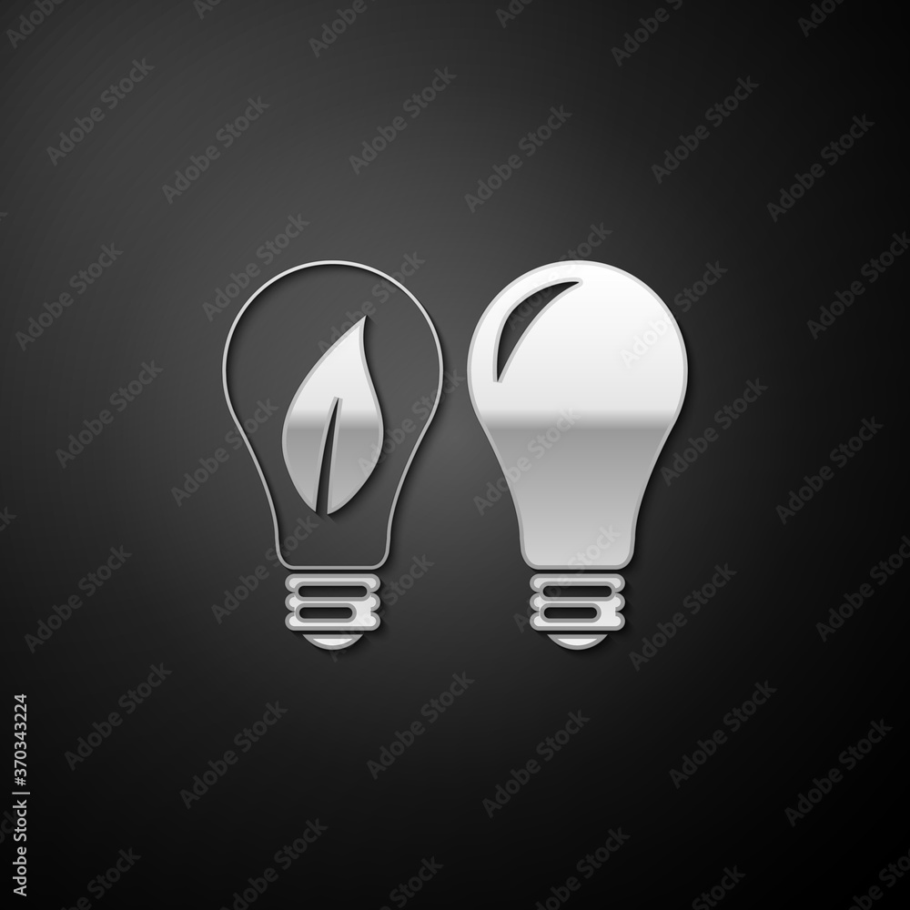 Silver Classic Lamp and Light bulb with leaf inside icon isolated on black background. Lighting electric lamp. Green eco energy concept. Long shadow style. Vector. Silver Classic Lamp and Light bulb with leaf inside icon isolated on black background. Lighting electric lamp. Green eco energy concept. Long shadow style. Vector.