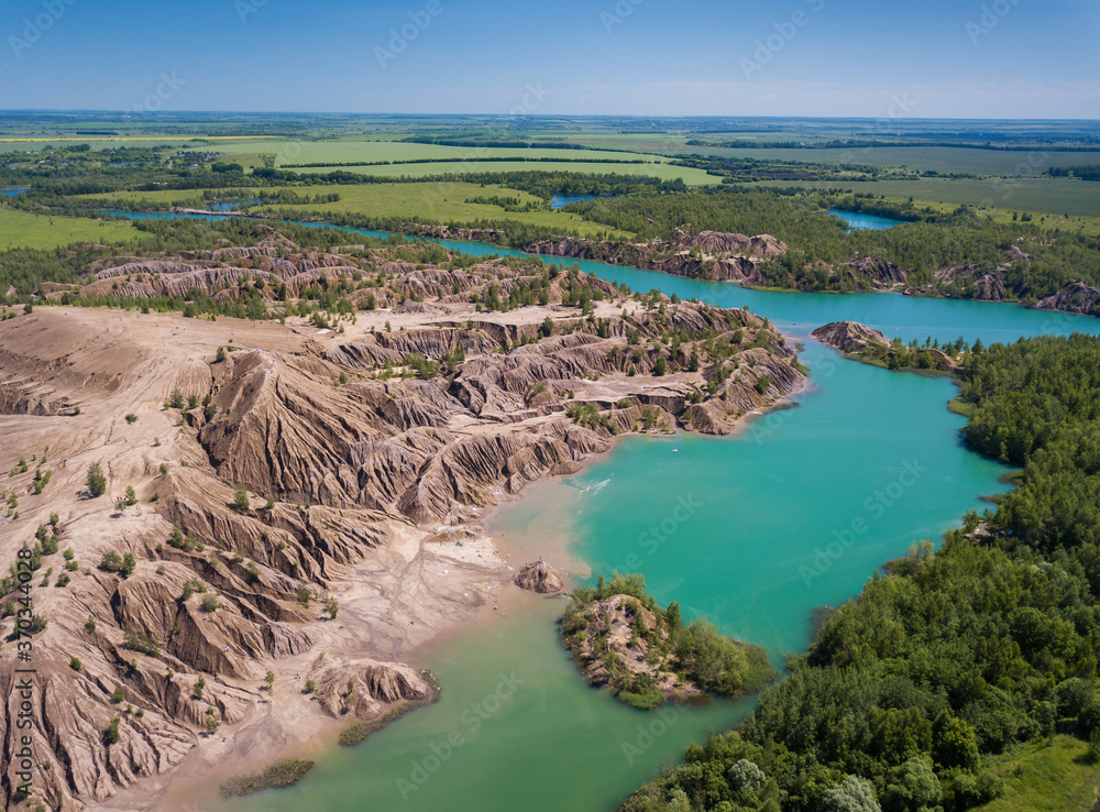 Fancy and unusual aerial landscape of Romantsev mountains wih blue lakes and mud erosion looks like alien surface of Mars. Fancy and unusual aerial landscape of Romantsev mountains wih blue lakes and mud erosion looks like alien surface of Mars.