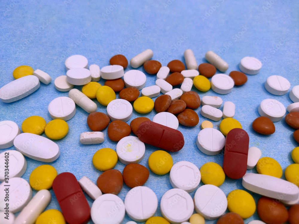 medicine pill and tablets spread on paper used in treatment of ill patients. medicine pill and tablets spread on paper used in treatment of ill patients.