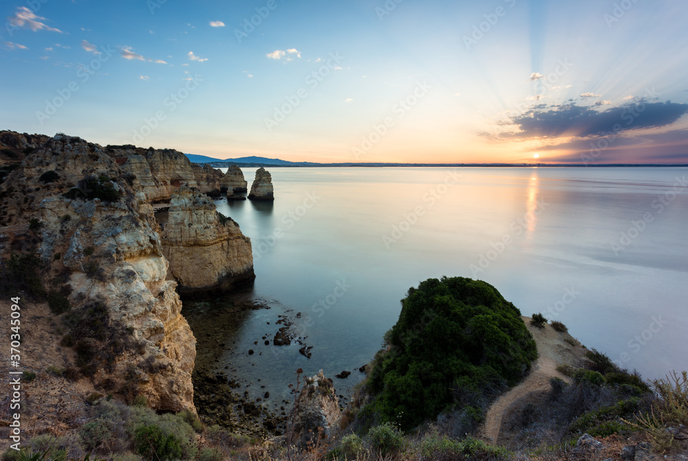 Landscape with the rocks of Ponta da Piedade at sunrise near Lagos and Luz at Algarve, Portugal
