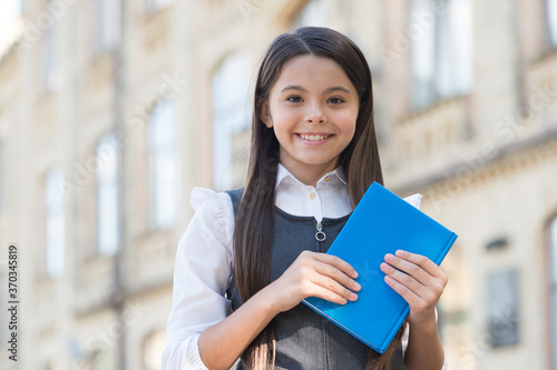 Expand your brain by reading. Happy child hold book outdoors. School library. Reading habit. Home reading. Childs imagination and fantasy. Formal and informal education. Human mind needs knowledge photo