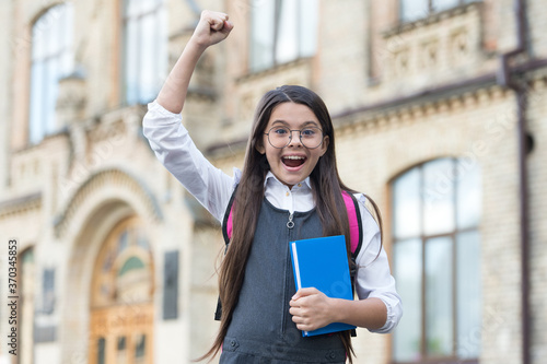 Yes, we make winners. Happy winner outdoors. Small kid make winning gesture. Scholarship winner. Success in study. Back to school. Formal education. Knowledge day. September 1. You can do it