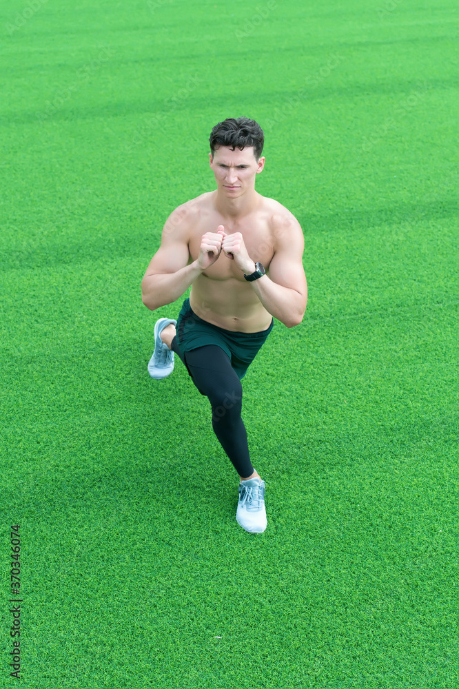 fitness man working out outdoor. man training body. man with muscular body. sporty person doing stretching outside. Keeping those muscles flexible. Great warm-up. Staying fit and healthy