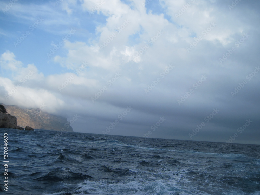 Scenic panoramic view of Mediterranean Sea in storm. Beautiful power blue and white waves on a rainy day.