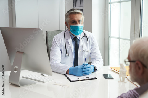 Protective masks and gloves are worn by all medical staff regardless