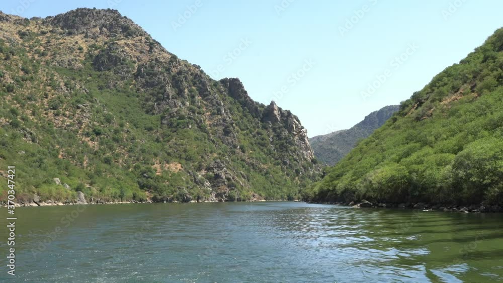 Boat wake while observing a beautiful landscape of a river among mountains Boat wake while observing a beautiful landscape of a river among mountains