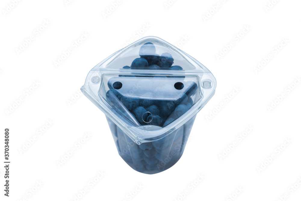 Blueberries in a plastic container isolated. Blueberries in a plastic container isolated.