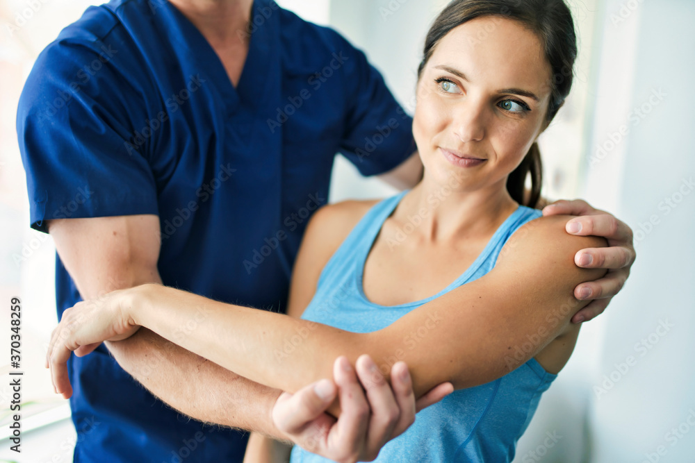 Male Physical Therapist Stretching a Female Patient Slowly. Male Physical Therapist Stretching a Female Patient Slowly.