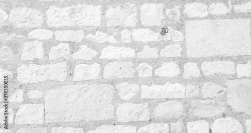 White texture of an old wall made of hewn stones - old vintage texture design - large image in high resolution 
