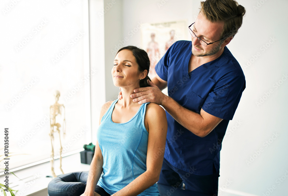 Male Physical Therapist Stretching a Female Patient nack Male Physical Therapist Stretching a Female Patient nack