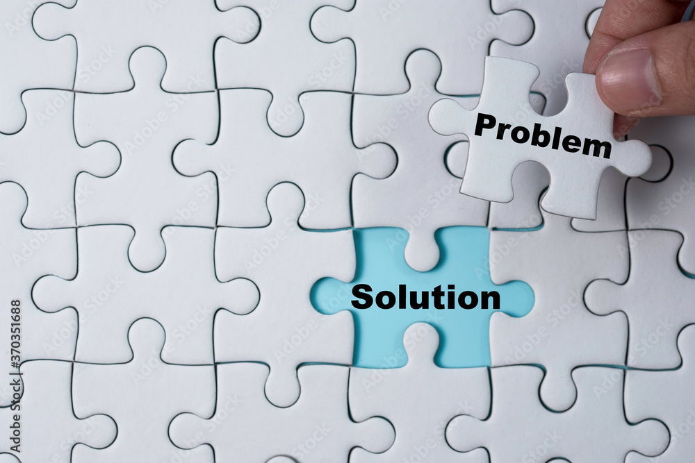 Hand holding and putting problem jigsaw puzzle to solution. Problem solving concept. Hand holding and putting problem jigsaw puzzle to solution. Problem solving concept.